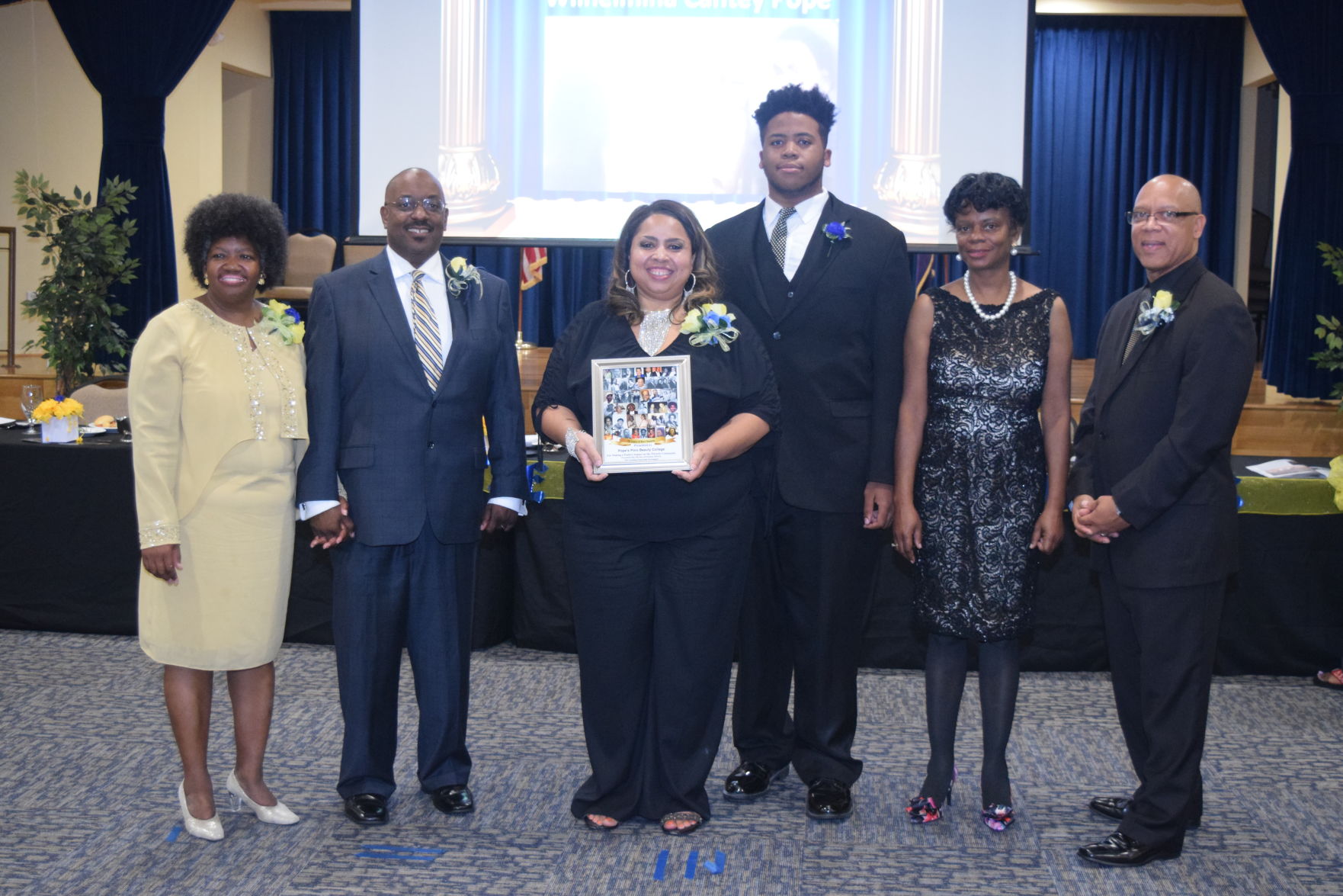 Alvera Butler & Son Zachary Butler receives Legacy Award for Pope's Pora Beauty College.